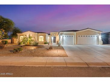 Charming single-Gathering home with a three-car garage and professionally landscaped front yard at 3125 W Desert Ln, Laveen, AZ 85339
