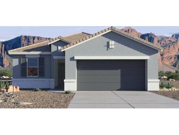 A single-story home with a gray exterior, two-car garage, desert landscaping, and a mountain backdrop at 35500 N Common Ct, San Tan Valley, AZ 85140