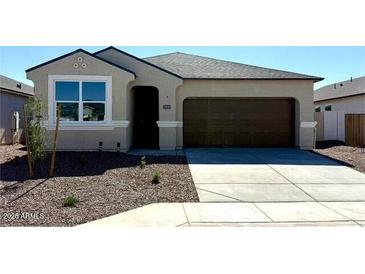 Charming single-story home features a 2-car garage, desert landscaping and neutral color palette at 35545 N Breezy Ln, San Tan Valley, AZ 85140