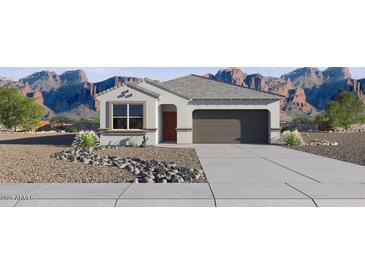 Charming single story home showcasing desert landscaping and a two car garage at 35545 N Breezy Ln, San Tan Valley, AZ 85140