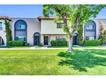 Charming townhome featuring well-maintained landscaping and inviting curb appeal with mature trees at 3820 N 30Th St, Phoenix, AZ 85016