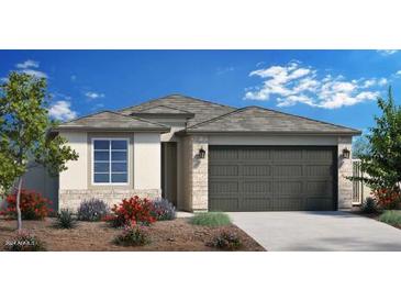 Charming single-story home with a neutral color palette, well-manicured landscaping, and a two-car garage at 4949 W Walatowa St, Laveen, AZ 85339