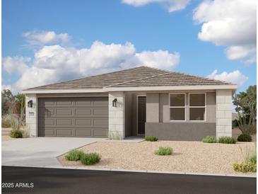 Charming single-story home with a two-car garage and low-maintenance desert landscaping at 5634 W Olney Ave, Laveen, AZ 85339