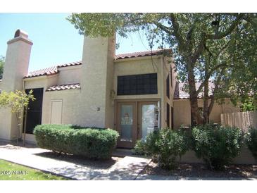 Inviting front exterior featuring a tile roof, chimney, and well-maintained landscaping at 602 N May St # 65, Mesa, AZ 85201