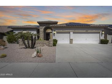 Charming single-story home with a three-car garage, solar panels, and a desert-style front yard at 8712 W Sequoia Dr, Peoria, AZ 85382