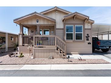 Inviting single-story home features a quaint front porch and neutral colored exterior at 9333 E University Dr # 194, Mesa, AZ 85207