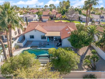 Stunning aerial view of a home featuring a private pool, patio, and beautiful landscaping with palm trees at 10248 E San Salvador Dr, Scottsdale, AZ 85258