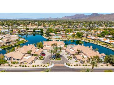 Stunning aerial view of waterfront homes boasting well-manicured landscaping and a beautiful lake at 10390 E Lakeview Dr # 204, Scottsdale, AZ 85258