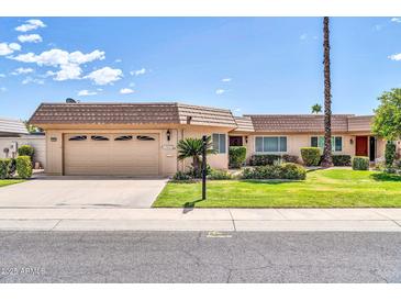 Charming single-story home with attached garage and a well-manicured front yard, perfect for suburban living at 10601 W Hutton Dr, Sun City, AZ 85351