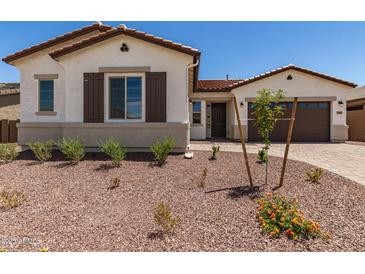 Charming single-story home featuring desert landscaping, a cozy front porch, and a two-car garage at 20255 W Monterey Way, Buckeye, AZ 85396