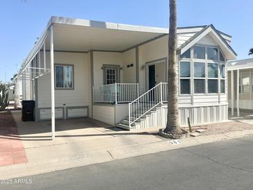 Charming single-story home with large windows and covered parking, perfect for easy living at 381 S Gypsum Dr, Apache Junction, AZ 85119