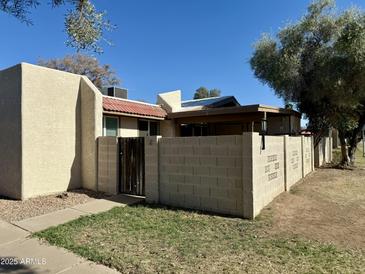 Charming single story home with a red tile roof and a private walled front yard at 555 N May -- # 1, Mesa, AZ 85201
