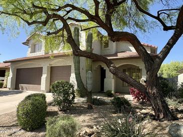 Charming two-story home featuring a two-car garage and desert landscaping at 7336 E Overlook Dr, Scottsdale, AZ 85255