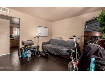 Cozy living area featuring a whiteboard, comfortable seating, and ample space for a small kitchenette at 801 E Oakland St, Chandler, AZ 85225