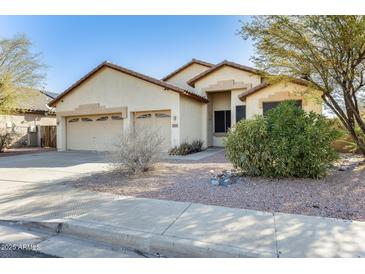 Charming single-story home featuring a three-car garage and a well-maintained, low-water landscape at 809 S 120Th Ave, Avondale, AZ 85323