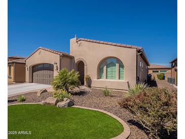 Charming single-story home with desert landscaping and an arched window at 132 E El Prado Dr, Queen Creek, AZ 85140