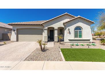 Charming single-story home featuring a well-maintained front yard, paved driveway, and attached garage at 19038 N Arbor Dr, Maricopa, AZ 85138