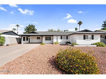 Charming single-story home with well-maintained landscaping and a spacious driveway at 2232 E Karen Dr, Phoenix, AZ 85022