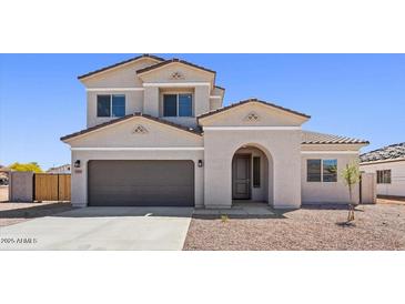 Charming two-story home with a two-car garage and low-maintenance desert landscaping at 2530 N Pony Ln, Casa Grande, AZ 85122