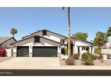Charming single-Gathering home with a three-car garage and well-manicured landscaping at 6174 E Janice Way, Scottsdale, AZ 85254