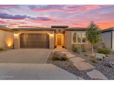 Charming single-story home with a two-car garage, desert landscaping, and a paver walkway at 175 E Santa Lucia Ln, Queen Creek, AZ 85140