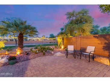 Enjoy a relaxing evening on this cozy brick-paved patio with lush desert landscaping and charming accent lighting at 20555 N 261St Ave, Buckeye, AZ 85396