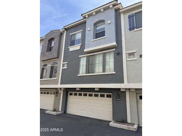 Charming townhome exterior with a two-car garage and stucco finish at 2402 E 5Th St # 1428, Tempe, AZ 85288