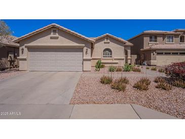 Charming single-story home featuring a two-car garage and desert landscaping at 2714 E Valencia Dr, Phoenix, AZ 85042