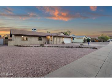 Charming single-story brick home with well-manicured desert landscaping and a two-car garage at 3121 E Sierra St, Phoenix, AZ 85028