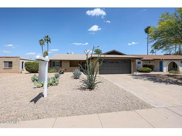 Charming single-story home with a xeriscaped front yard and a two-car garage at 510 E Fremont Dr, Tempe, AZ 85282