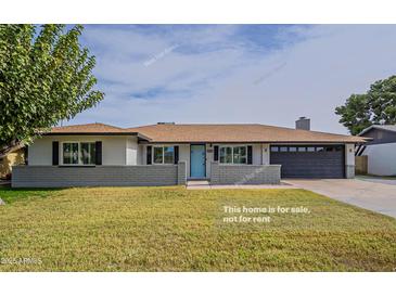 Charming single-story home features a well-manicured lawn and a two car garage at 5929 S Lakeshore Dr, Tempe, AZ 85283