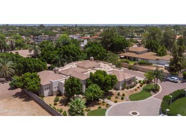 Expansive desert property featuring mature trees, private driveway and lush landscaping at 6243 E Camelback Rd, Scottsdale, AZ 85251