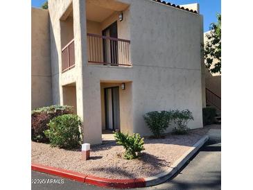 Exterior view of condo featuring balcony, desert landscaping, and neutral color scheme at 9340 N 92Nd St # 120, Scottsdale, AZ 85258