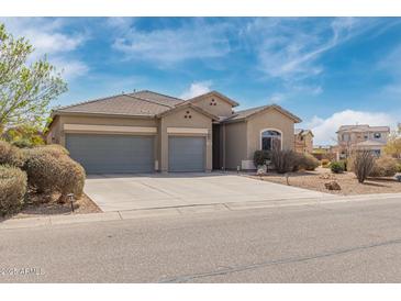 Charming single-story home featuring a three-car garage and well-maintained landscaping at 1085 W Ayrshire Trl, San Tan Valley, AZ 85143