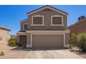 Two-story home with neutral colored stucco and a two car garage at 12517 W Santa Fe Ln, El Mirage, AZ 85335