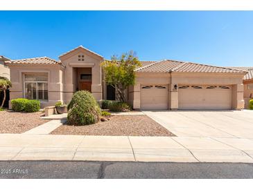 Charming home featuring a well-maintained yard, complemented by a three-car garage and a tile roof at 16211 S 4Th St, Phoenix, AZ 85048