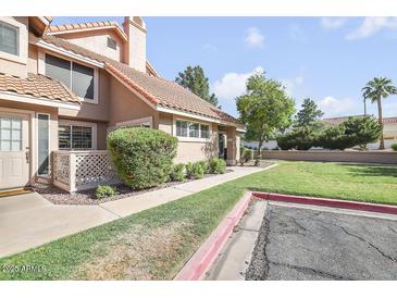Charming home featuring a well-manicured lawn, mature trees, and a welcoming front entrance at 1633 E Lakeside Dr # 139, Gilbert, AZ 85234