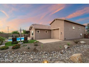 Charming single-Gathering home features a private pool, desert landscaping, and an attached garage at 24280 N 164Th Dr, Surprise, AZ 85387