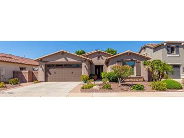 Charming single-story home featuring a well-maintained front yard with desert landscaping and a two car garage at 2680 E Lodgepole Dr, Gilbert, AZ 85298