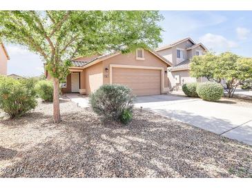 Charming single-story home featuring low-maintenance desert landscaping and a two-car garage at 41341 W Little Dr, Maricopa, AZ 85138