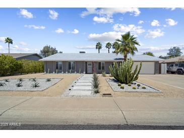Charming single-story home featuring desert landscaping with a rock lawn, walkway, and large cactus at 4904 E Tierra Buena Ln, Scottsdale, AZ 85254