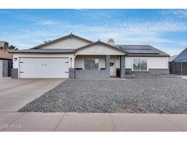 Charming single-story home with a well-maintained yard and a two-car garage on a beautiful sunny day at 5228 W Aster Dr, Glendale, AZ 85304