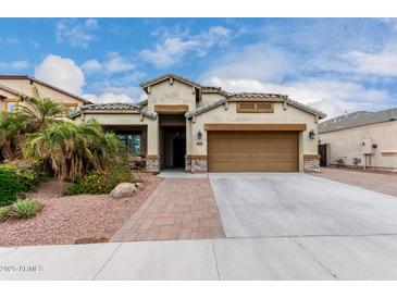 Charming single-Gathering home featuring a two-car garage, well-maintained landscaping, and a welcoming entrance at 6608 W Saguaro Park Ln, Glendale, AZ 85310