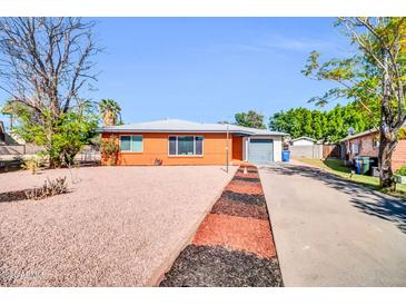 Lovely single-story brick home featuring desert landscaping, a driveway, and an attached garage at 7039 N 15Th St, Phoenix, AZ 85020