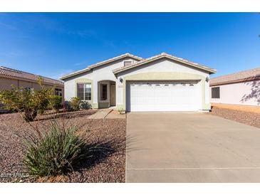 Charming single-story home featuring a two-car garage, landscaped front yard and neutral color palette at 8576 E Jasper St, Gold Canyon, AZ 85118