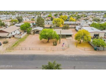 This is an aerial view of the home with mature trees, and ample parking space at 10437 E Boulder Dr, Apache Junction, AZ 85120