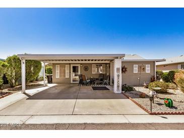 Charming home featuring a covered parking area and inviting outdoor seating at 215 N Power Rd # 340, Mesa, AZ 85205