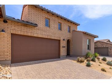 Charming home with a two-car garage, beautiful brickwork and a well-kept desert landscaped yard at 26699 N 104Th Way, Scottsdale, AZ 85262