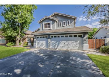 Charming two-story home with a three-car garage and manicured lawn at 3252 E Lexington Ave, Gilbert, AZ 85234