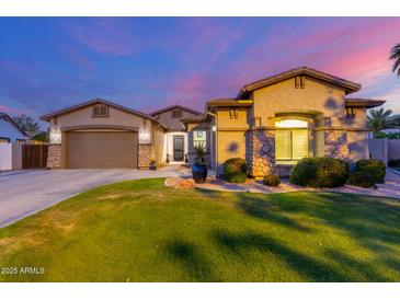 Charming single-story home boasts a well-manicured lawn and attractive desert landscaping at 5639 S Four Peaks Pl, Chandler, AZ 85249